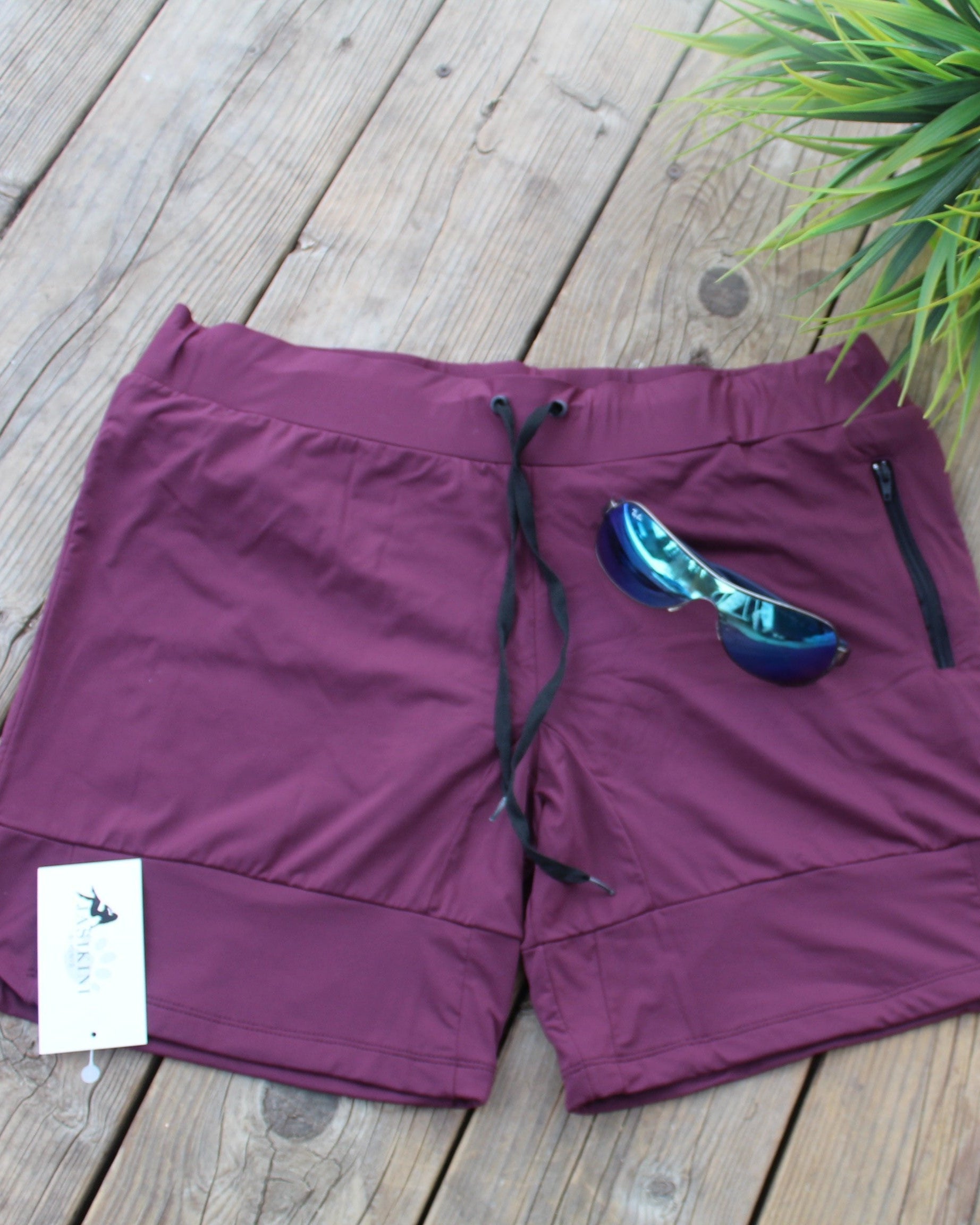 flat lay of mens swimshorts in purple - Jasikini swimwear