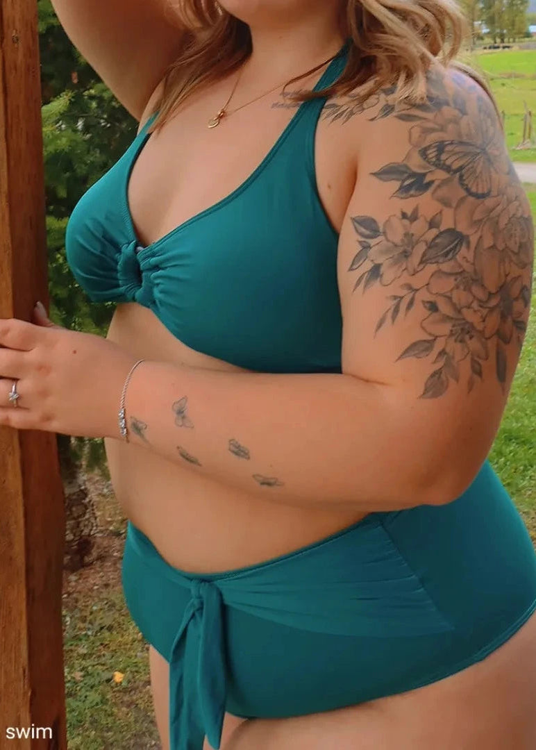 A woman wearing a forest green bikini with full coverage bottom - Jasikini swimwear.